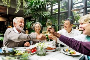 group of senior citizens making a toast